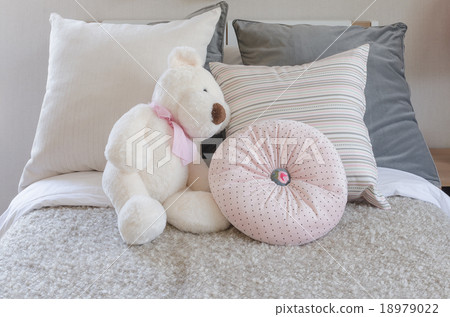 doll on kid's bed with pillows doll on kid's bed with pillows 18979022