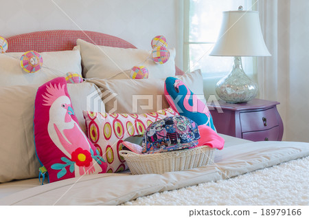 colorful hat in basket with pillows on kid's bed colorful hat in basket with pillows on kid's bed 18979166