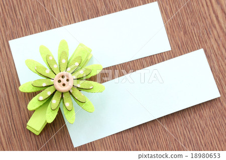 Green artificial flowers and note paper stuck on dark wood. Green artificial flowers and note paper stuck on dark wood. 18980653