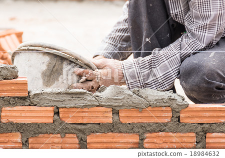Bricklayer working in construction site  18984632