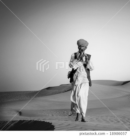 Indigenous Indian Man Playing Wind Pipe In A Desert Concept 18986037