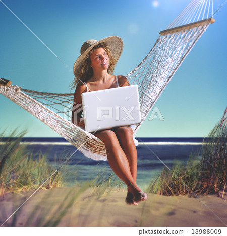 Beautiful Woman Sitting on a Hammock by the Beach Concept 18988009