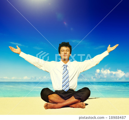 Businessman meditating on the beach Concept 18988487