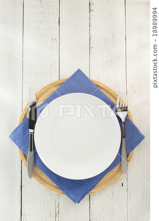 knife and fork with plate at napkin on wood 18989994