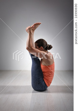 Sporty woman practices yoga asana Urdhva mukha  18990690