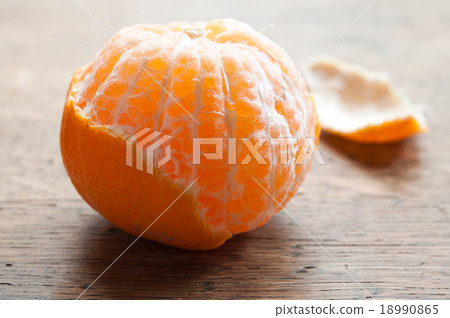 peeled tangerine on wooden background peeled tangerine on wooden background 18990865