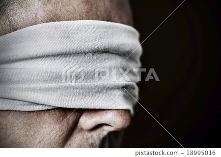 young man with a blindfold in his eyes young man with a blindfold in his eyes 18995016