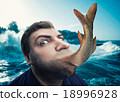 Man eating fish 18996928