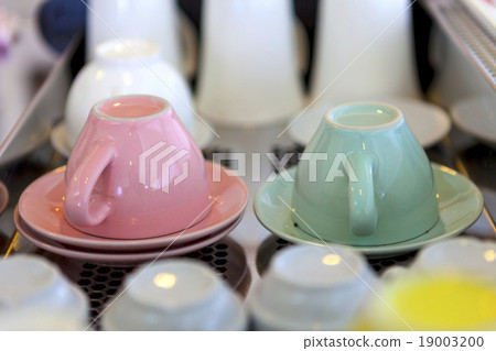 pink and green coffee cups overturned  19003200