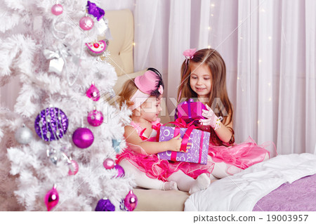 Girls show off the gifts for Christmas. 19003957