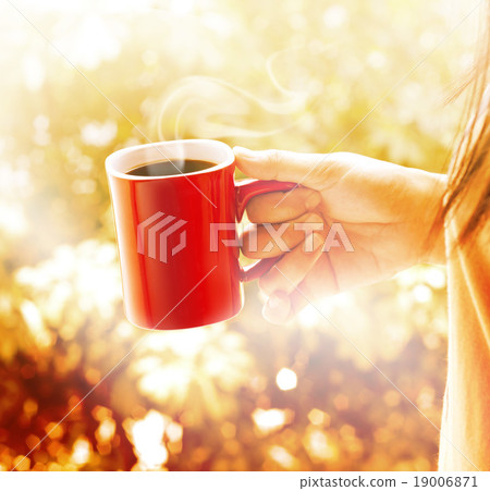 Woman with cup of coffee vibrant brown background 19006871