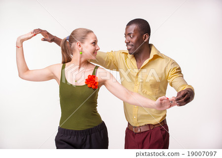 Young couple dances Caribbean Salsa, studio shot 19007097