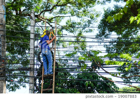 A man working on stairs hold big wire cutters  19007883
