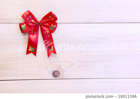 Christmas ribbon on wood background. Christmas ribbon on wood background. 19011396