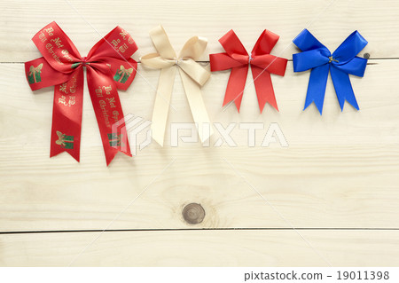 Christmas ribbons on wood background. Christmas ribbons on wood background. 19011398