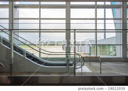 The airport escalator with view to the outside The airport escalator with view to the outside 19012039