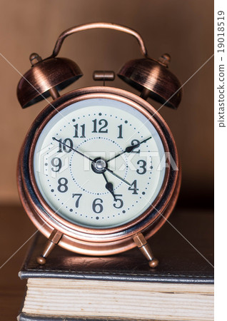 Alarm clock and book. 19018519