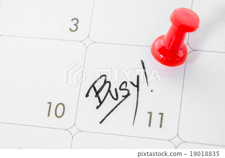 The words Busy written on a white calendar. The words Busy written on a white calendar. 19018835