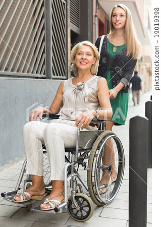 Social worker and disabled woman at stroll Social worker and disabled woman at stroll 19019398