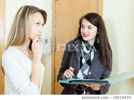 woman conducting survey among residents woman conducting survey among residents 19019474