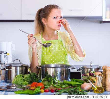 Worried housewife with spoiled food. Worried housewife with spoiled food. 19019761