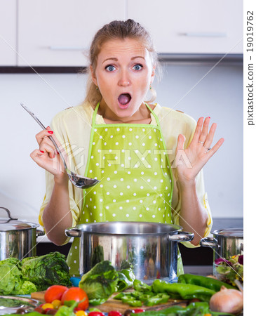 Worried housewife with spoiled food. 19019762