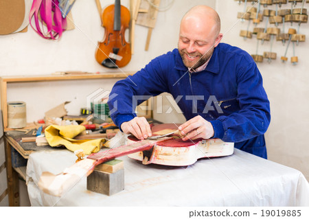 Guitar-maker at workshop. 19019885