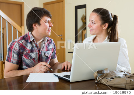Couple working on laptop computer 19019970