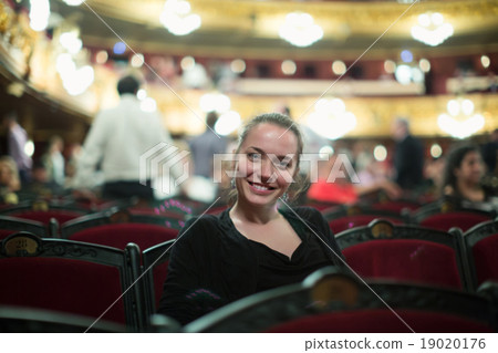 Woman in auditorium of teatre 19020176