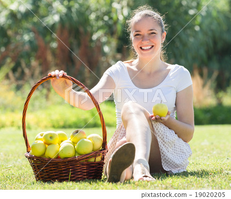 Girl with a basket of apples outdoor 19020205