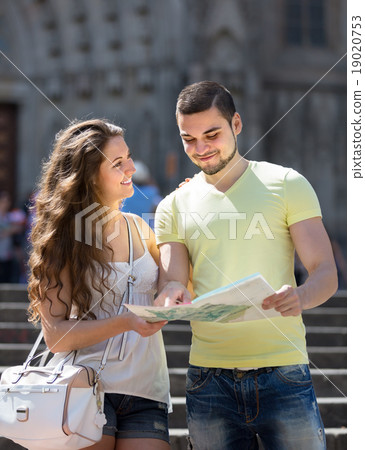 Two friends with map in the street Two friends with map in the street 19020753