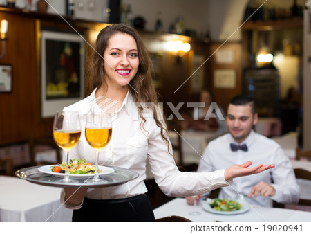 Beautiful waitress in restaurant 19020941