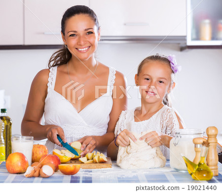 Woman and child cooking strudel 19021440