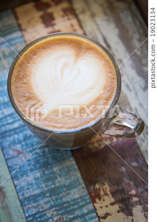 Heart latte art coffee on vintage wooden tray 19023134