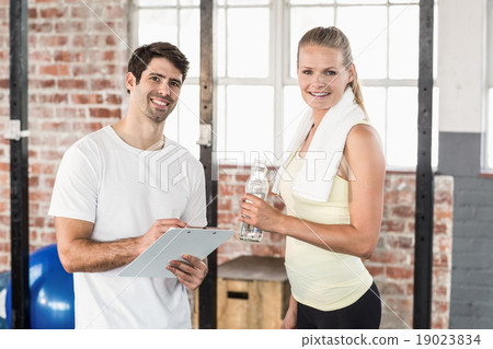 Muscular woman watching her results on clipboard Muscular woman watching her results on clipboard 19023834