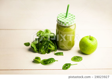 High angle view of juice jar with green apple and basil 19023927