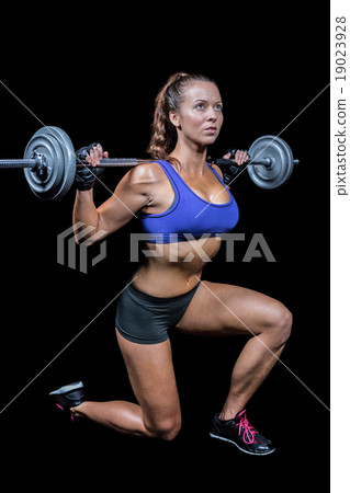 Fit woman exercising while lifting crossfit Fit woman exercising while lifting crossfit 19023928