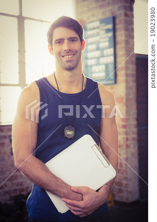 Portrait of a trainer holding clipboard Portrait of a trainer holding clipboard 19023980