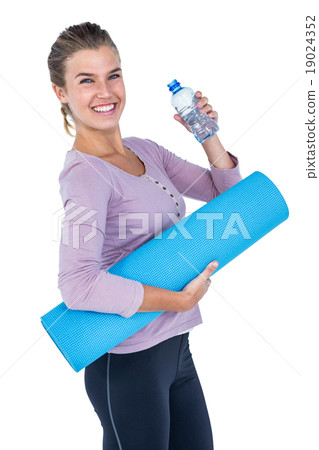 Woman holding water bottle and exercise mat Woman holding water bottle and exercise mat 19024352