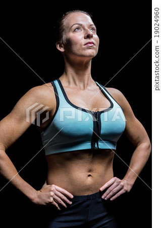 Thoughtful athlete looking up with hand on hip 19024960