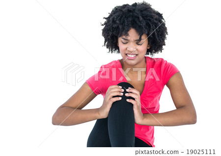 Young woman massaging knee 19025111