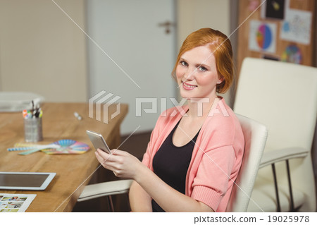 Smiling businesswoman using phone 19025978