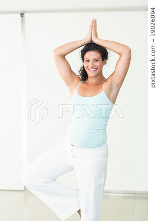 Happy pregnant woman in tree position Happy pregnant woman in tree position 19026094