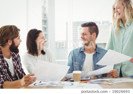 Smiling creative business people working at desk Smiling creative business people working at desk 19026693