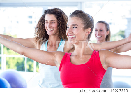 Cheerful women with arms outstretched Cheerful women with arms outstretched 19027213