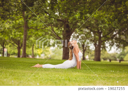 Side view of woman with eyes closed while stretching her body 19027255