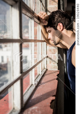 Handsome man looking outside window 19028440