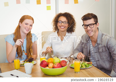 Smiling business people having lunch Smiling business people having lunch 19028519
