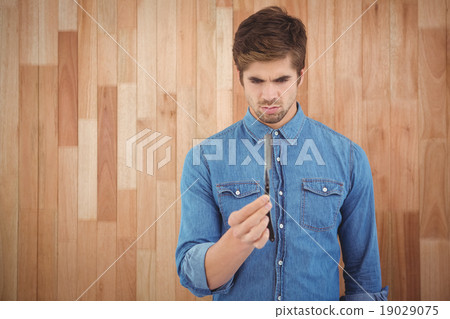Concentrated hipster holding straight edge razor Concentrated hipster holding straight edge razor 19029075