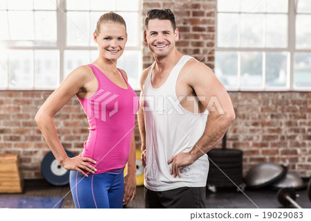Standing muscular couple facing the camera Standing muscular couple facing the camera 19029083